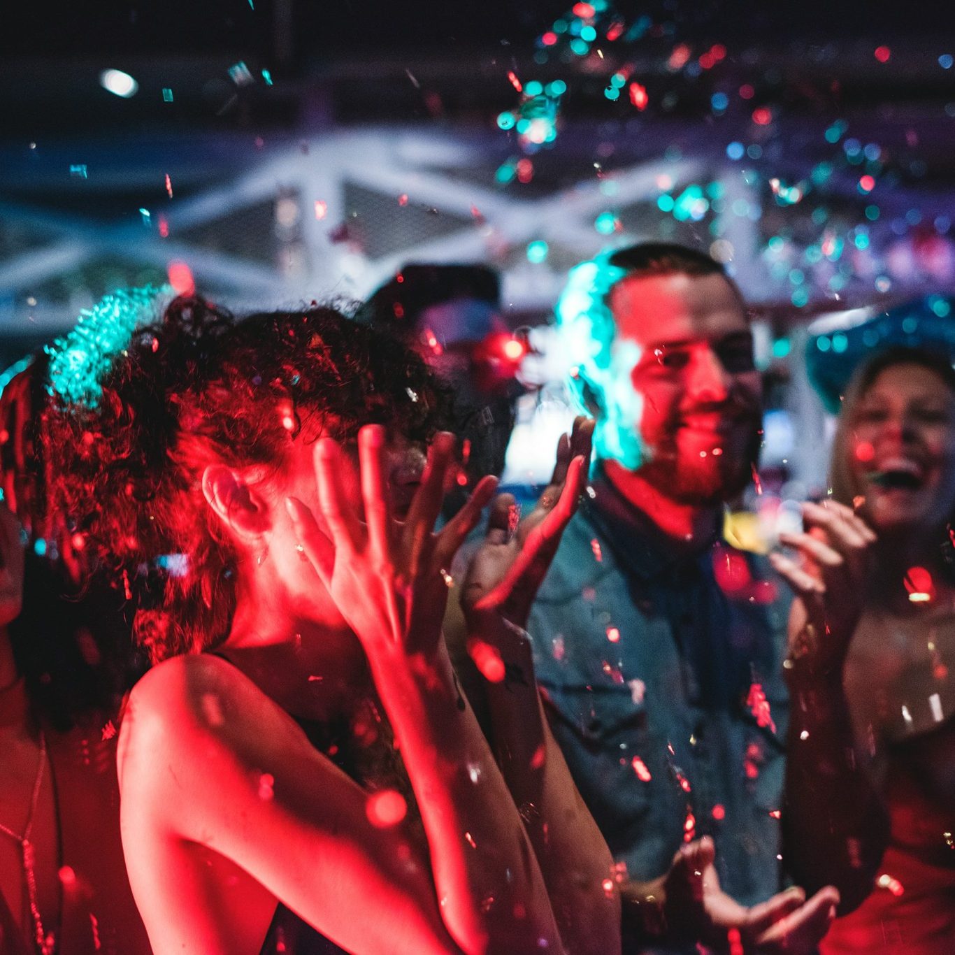 Eventfotografie Menschen auf einer Party mit bunten Lichtern und Konfetti